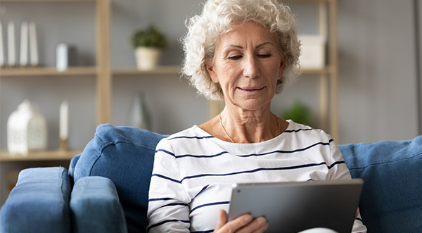 Woman reading her paper healthcare billing statement.