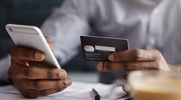 Man paying his healthcare bill using his mobile device.