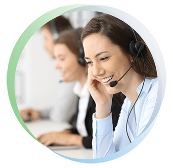 Woman receptionist smiles while listening to a phone call on a headset.